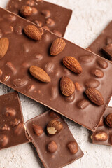 Sweet tasty chocolate with nuts on  light background