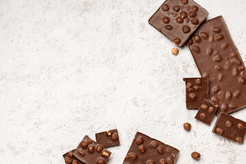 Sweet tasty chocolate with nuts on  light background