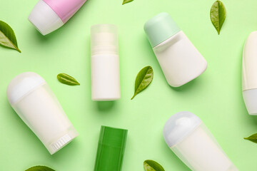 Deodorants with leaves on light green background