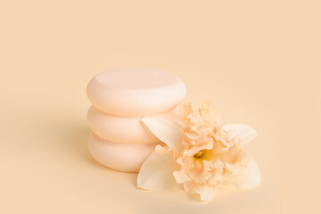 Decorative plaster podiums with flowers on yellow background