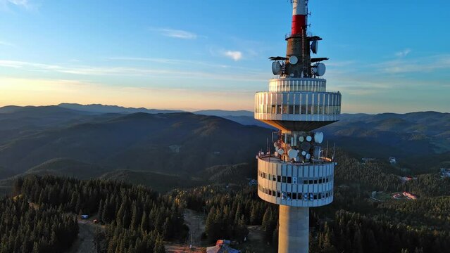 Tower Snezhana on peak of Snezhana covered with spruce forests in Rhodope mountains