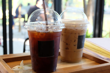 Close up plastic take away cup of iced black coffee and Latte