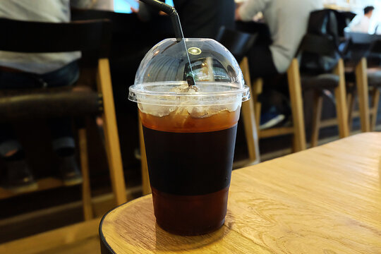 Close up plastic take away cup of iced black coffee