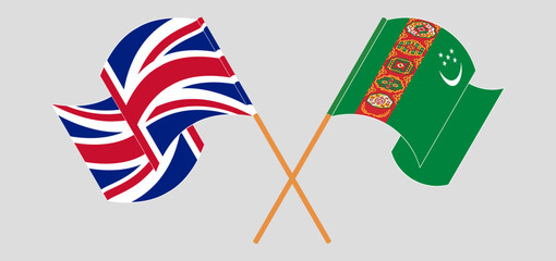 Obraz premium Crossed and waving flags of United Kingdom and Turkmenistan