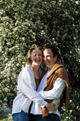 Portrait man and woman laughing together.Romantic affectionate couple on a holiday.Couple embracing and smiling. Sunset sunshine