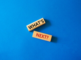What is next symbol. Concept words What is next on wooden blocks. Beautiful blue background. Business and What is next concept. Copy space.