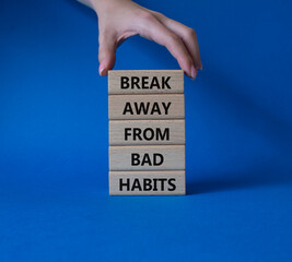 Break away from bad habits symbol. Wooden blocks with words Break away from bad habits. Beautiful blue background. Businessman hand. Business and Break away from bad habits concept. Copy space.