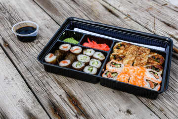 Set of the different sushi on wooden table