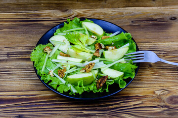 Plate with waldorf salad on a wooden table