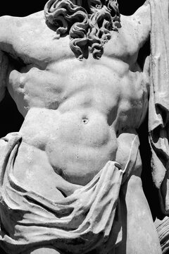 Torso of the mighty god Zeus. A fragment of an ancient statue. Black and white image.