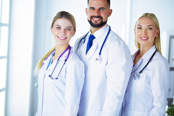 Smiling doctors all standing together as they work.