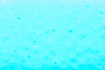 Cosmetic gel close-up with oxygen bubbles. Textured background with microbrushes in cosmetics. Moisturizing skin serum with vitamins and collagen.