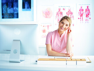 Woman doctor sitting with folder at hospital.