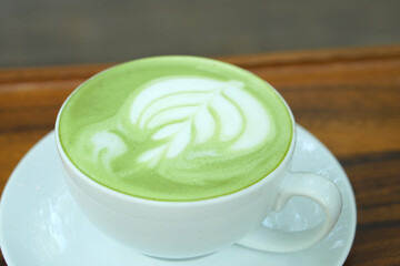 Hot green tea. Flower bubbles in a glass.