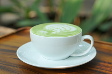 Hot green tea. Flower bubbles in a glass.