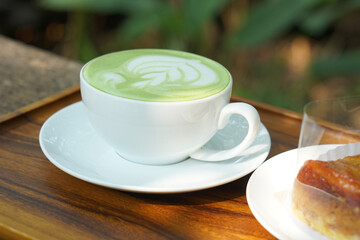 Hot green tea. Flower bubbles in a glass.