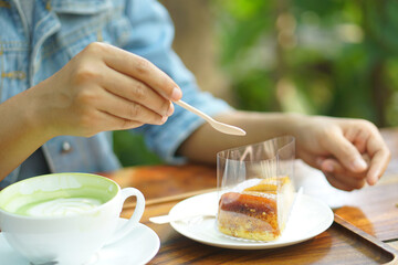 Woman eating cake in coffee cafe