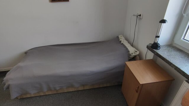 Room in the student dormitory. Bed in student room