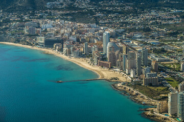 Fototapeta premium modern apartments, Cantal Roig beach and sailboats and fishing boats in the port of Calpe. Top view, horizontal