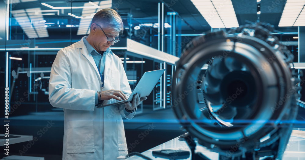Poster adult chief engineer using laptop computer, analyzing and researching how a futuristic turbofan moto