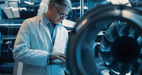 Software Developer and Machinery Operator Working on a Prototype Turbine Engine, Standing with...