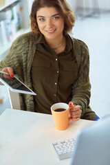 Beautiful smiling female student using online education service.