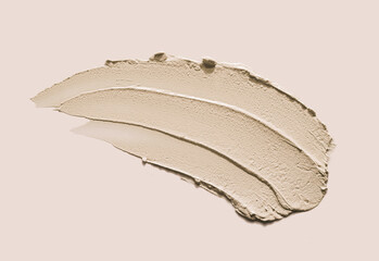 Cosmetic gray texture mud clay mask swatch isolated on beige background