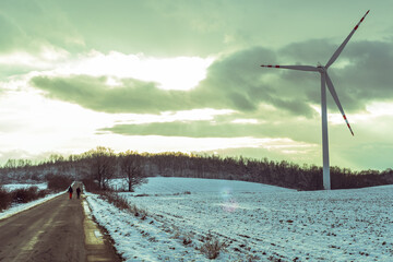 Fototapeta na wymiar windmill near the asphalt road in winter