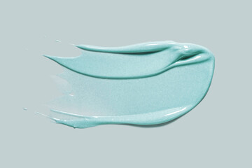 Blue green emerald colored cosmetic gel gray background isolated