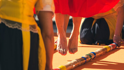 Jumping feet performing Tinikling, probably the most popular folk dance in the Philippines. The dancer imitates the movements of the bird by skillfully maneuvering between two large bamboo piles.