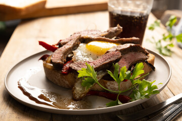 Juicy Beef Steak with Fried Egg and Fresh Vegetables: A Mouthwatering Delight for Meat Lovers!