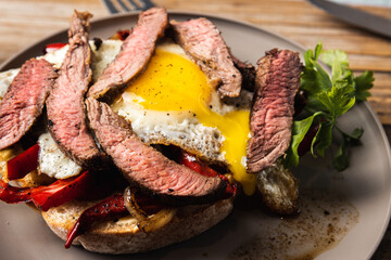 Juicy Beef Steak with Fried Egg and Fresh Vegetables: A Mouthwatering Delight for Meat Lovers!