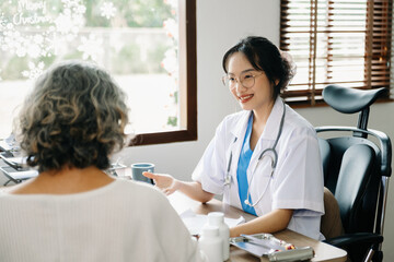 Obraz premium Asian Doctor and patient discussing something while sitting at the table . Medicine concept.