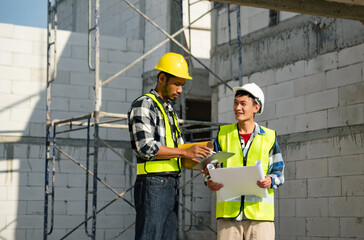 Engineers are discussing data working and laptop or tablet with architectural project at new construction site on big project..