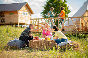 Group of best friends meeting all together at the campsite together they have fun time discussing and enjoy the time together in the middle of nature