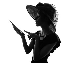 Trends come and go but style is forever. Studio shot of a stylish woman in silhouette using a digital table against a white background.