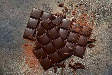 Food background with chocolate bars and cacao powder. Top view with copy space.