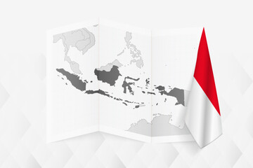 A grayscale map of Indonesia with a hanging Indonesian flag on one side. Vector map for many types of news.