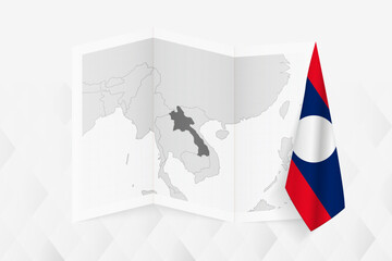 A grayscale map of Laos with a hanging Laotian flag on one side. Vector map for many types of news.