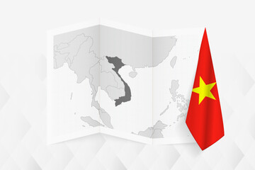 A grayscale map of Vietnam with a hanging Vietnamese flag on one side. Vector map for many types of news.