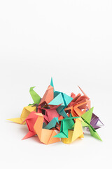 Creativity makes life more colourful. Studio shot of a pile of colourful origami birds.