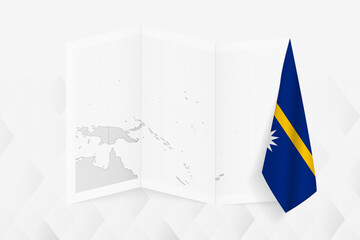 A grayscale map of Nauru with a hanging Nauruan flag on one side. Vector map for many types of news.