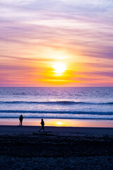 Fototapeta premium people enjoy beautiful summer sunset at the beach