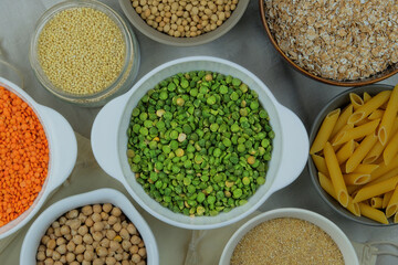 Green pea in bowl on a straw background. Vegetarian organic product. Vintage view. Top view.