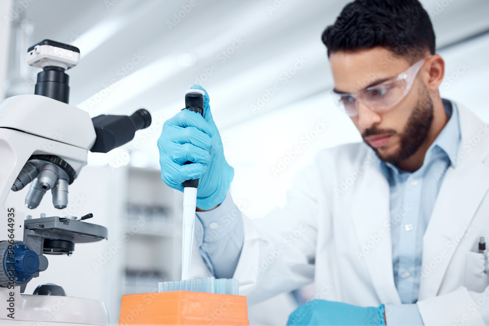 Aufkleber one mixed race male scientists wearing safety goggles and a labcoat while conducting medical researc