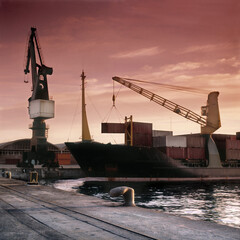 Shot film. Ancient view of ship loading activity at mediterranean port at dawn.