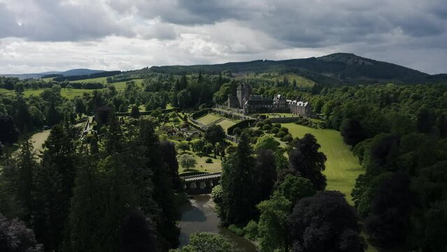 Establishing aerial view of Drummond Castle Gardens and its manicured lawn in Scotland.