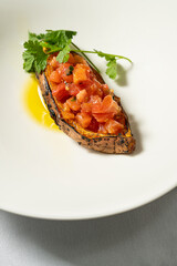 Baked sweet potato with fresh tomatoes