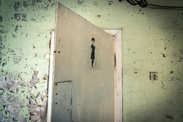 Bathroom door in old Jupiter Factory, Pripyat abandoned city in Chernobyl Exclusion Zone, Ukraine