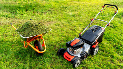 Lawn mover on green grass in modern garden. Machine for cutting lawns.